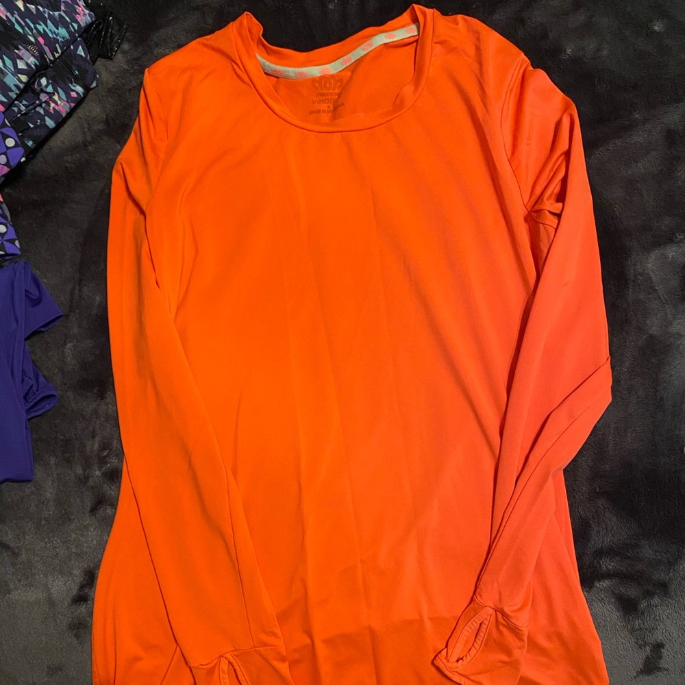Maurice’s in motion workout top. Orange size small